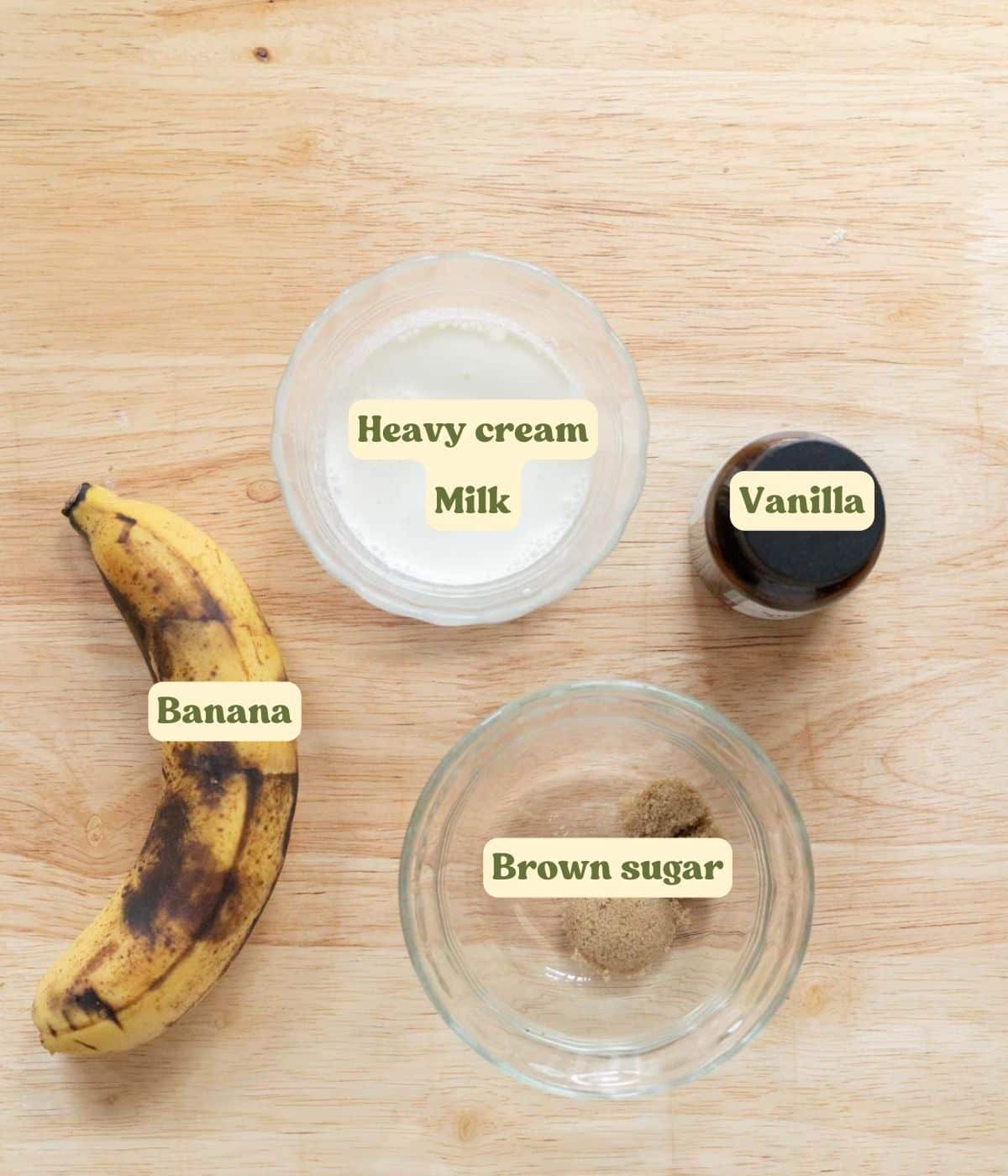 Labeled banana cold foam ingredients laid out on wooden table.