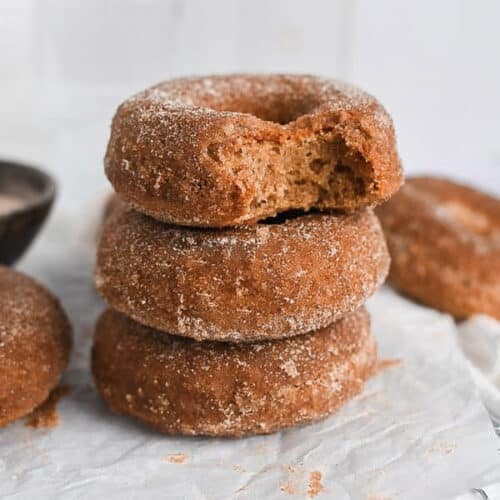 Cinnamon sugar mochi donuts stacked on top of one another.