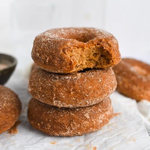 Cinnamon sugar mochi donuts on parchment paper.