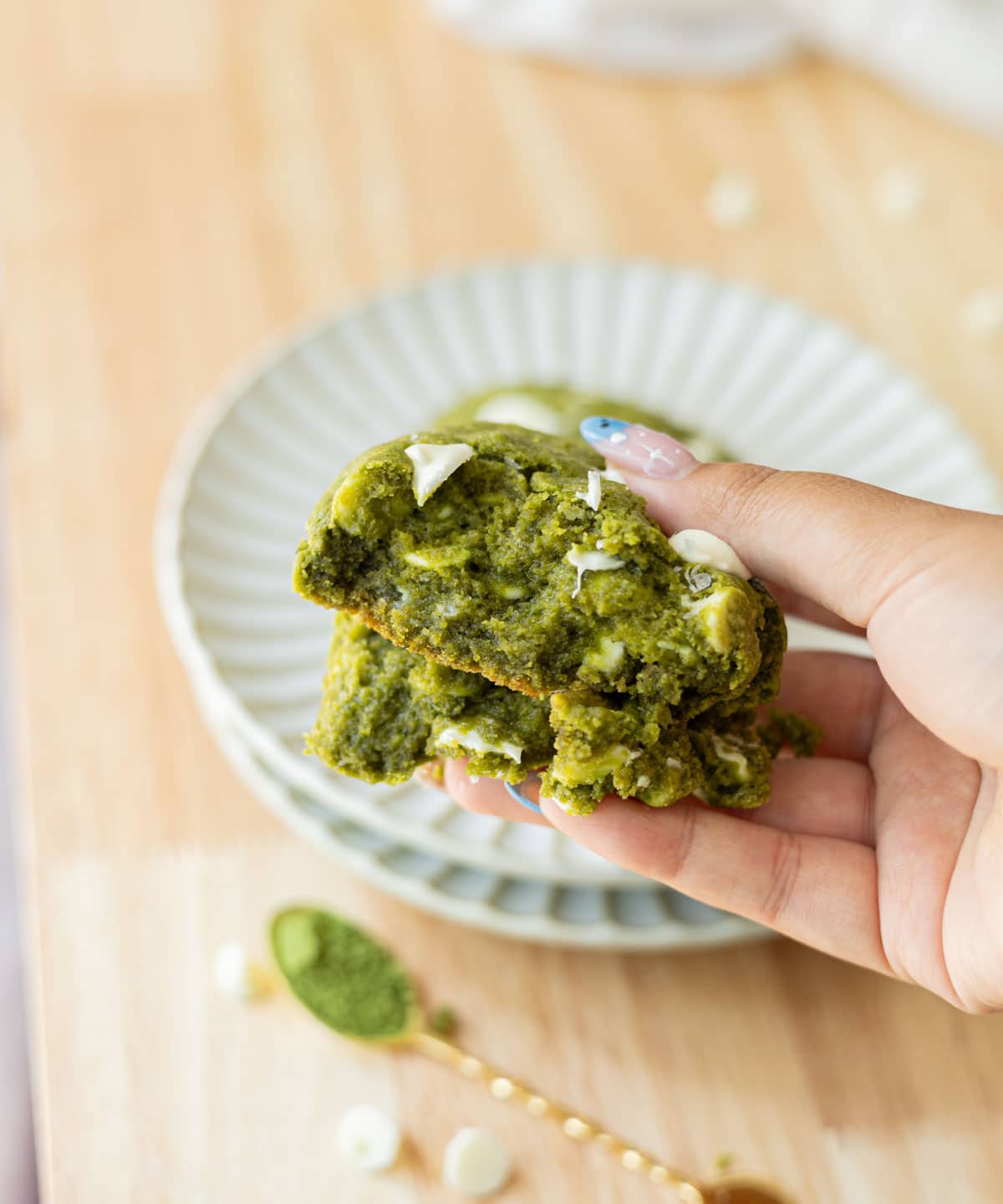 Gooey cross section of matcha cookies in hand.