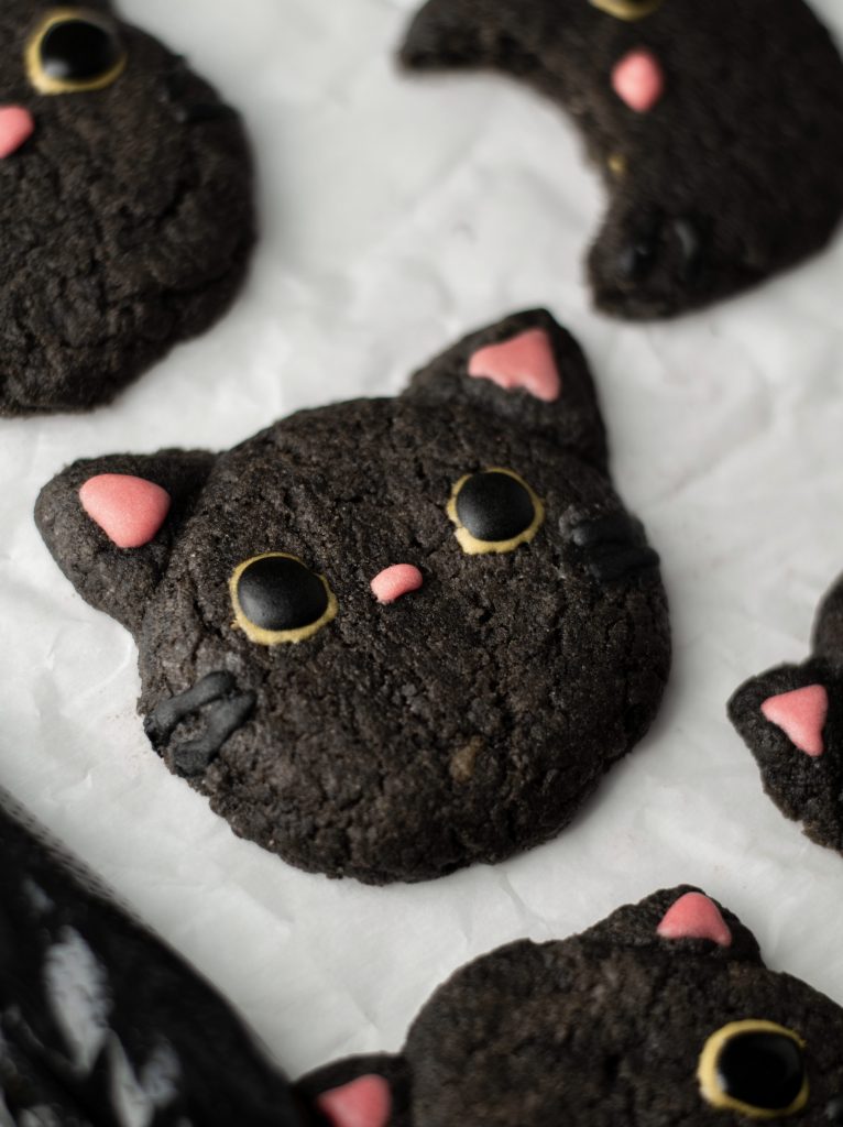 Black cocoa cat cookie with a cat face.