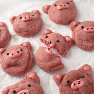 Pig cookies on crumpled parchment paper.