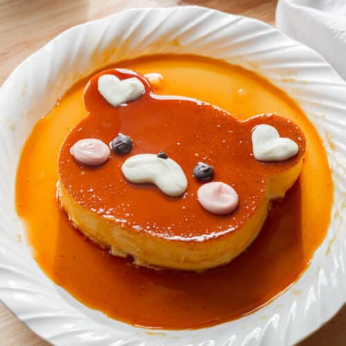 Cute bear leche flan on a white plate.