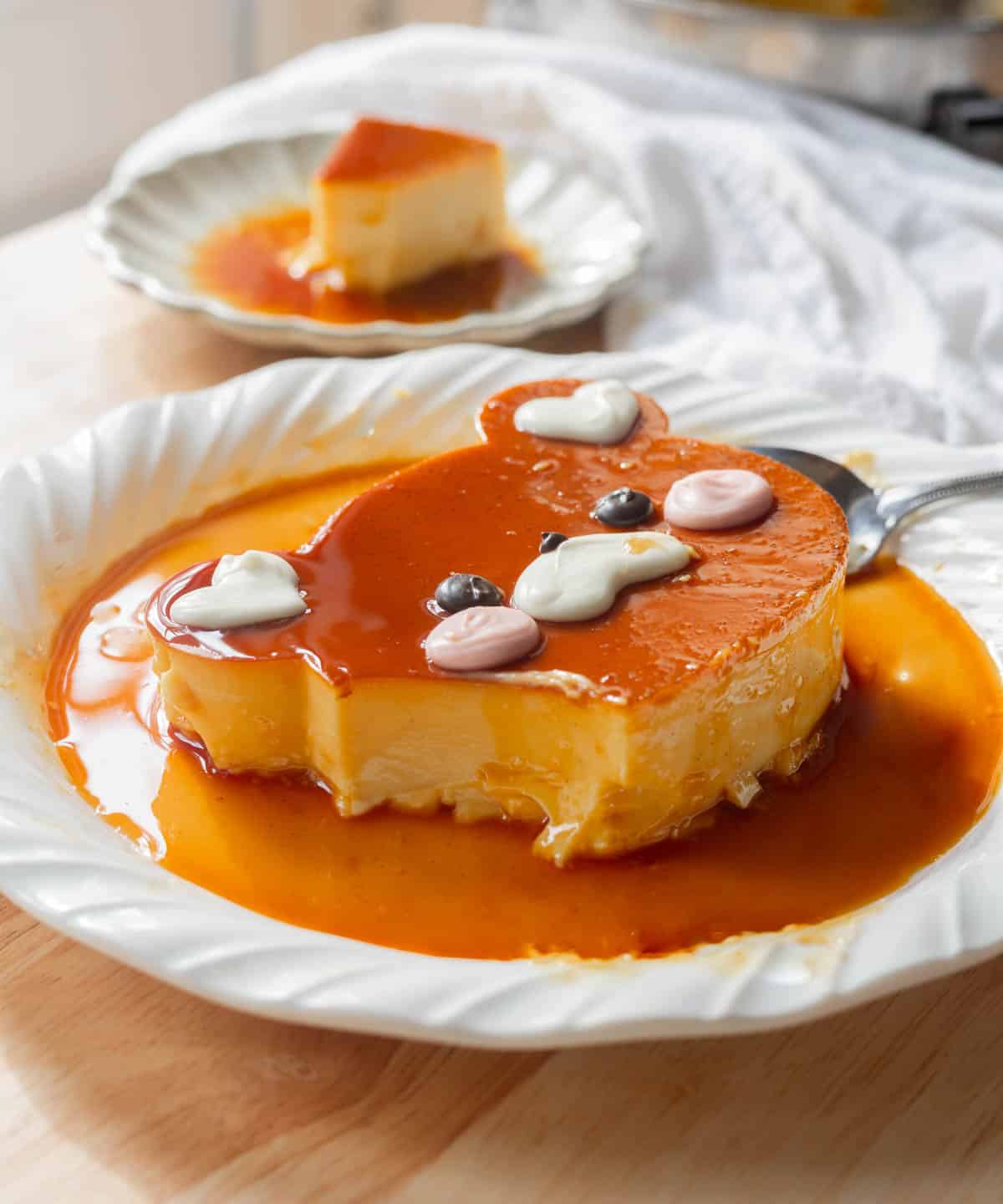 Cute bear flan with a bite taken out of it.