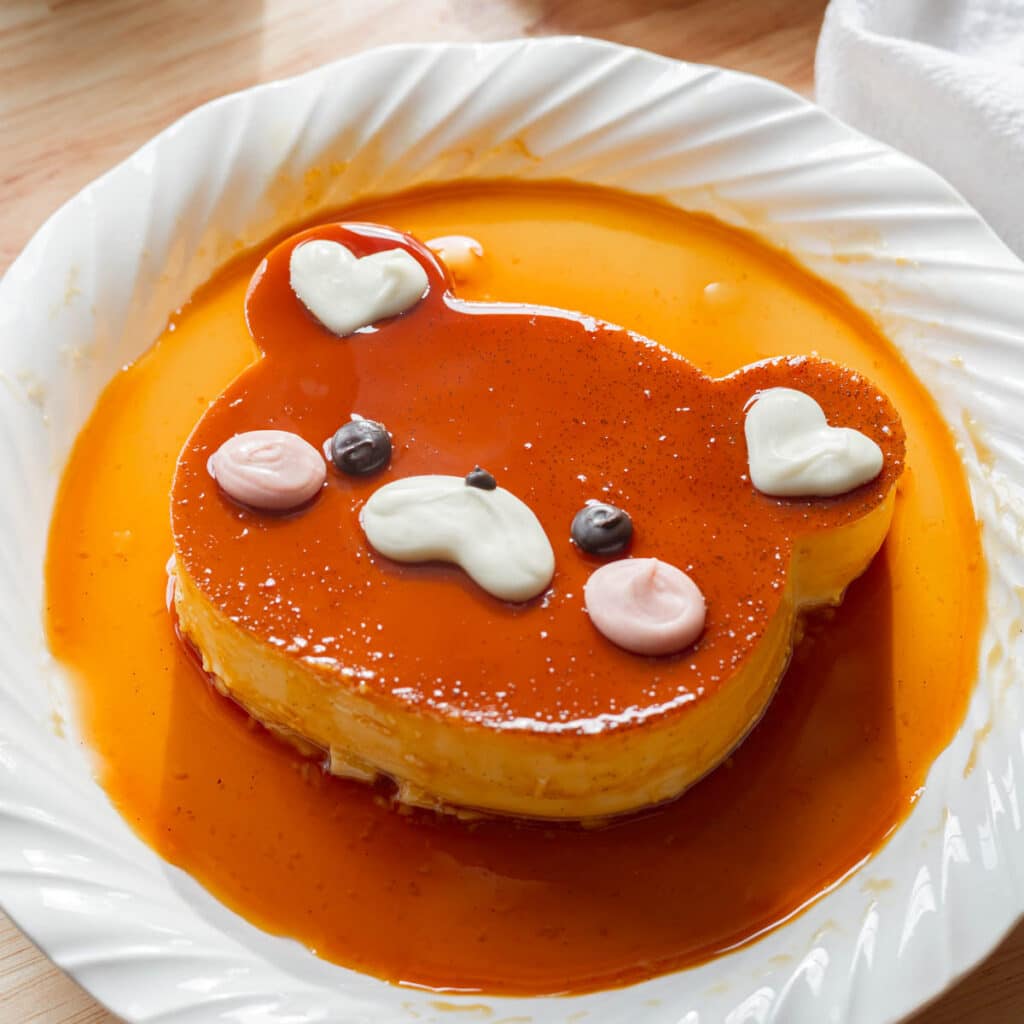 Cute bear leche flan on a white plate.