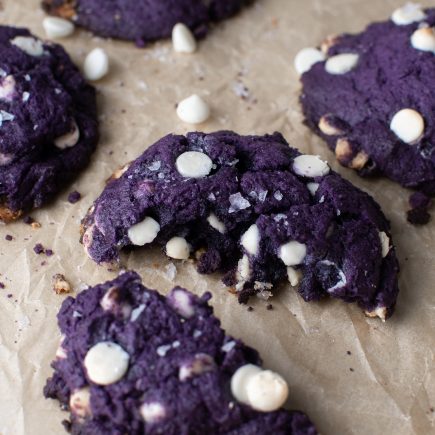 Chunky ube cookie split in half.