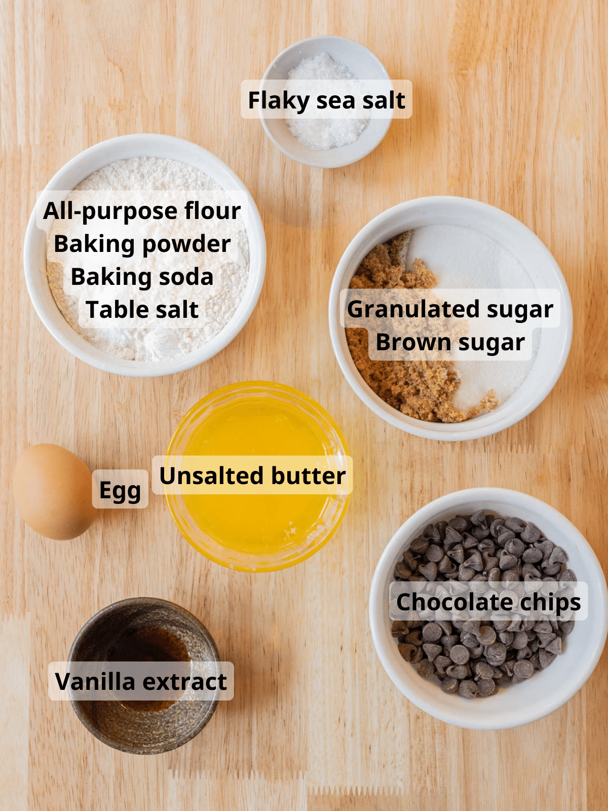 Labeled ingredients for teddy bear cookies on a wooden backdrop.