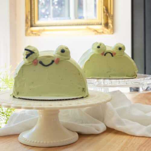 Cute matcha frog cakes on their own cake stands.