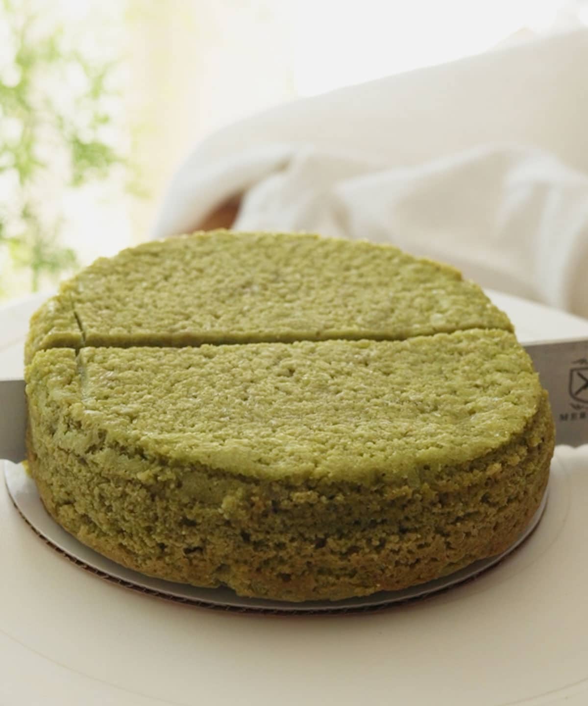 Slicing cake layer in half to create two half moons.