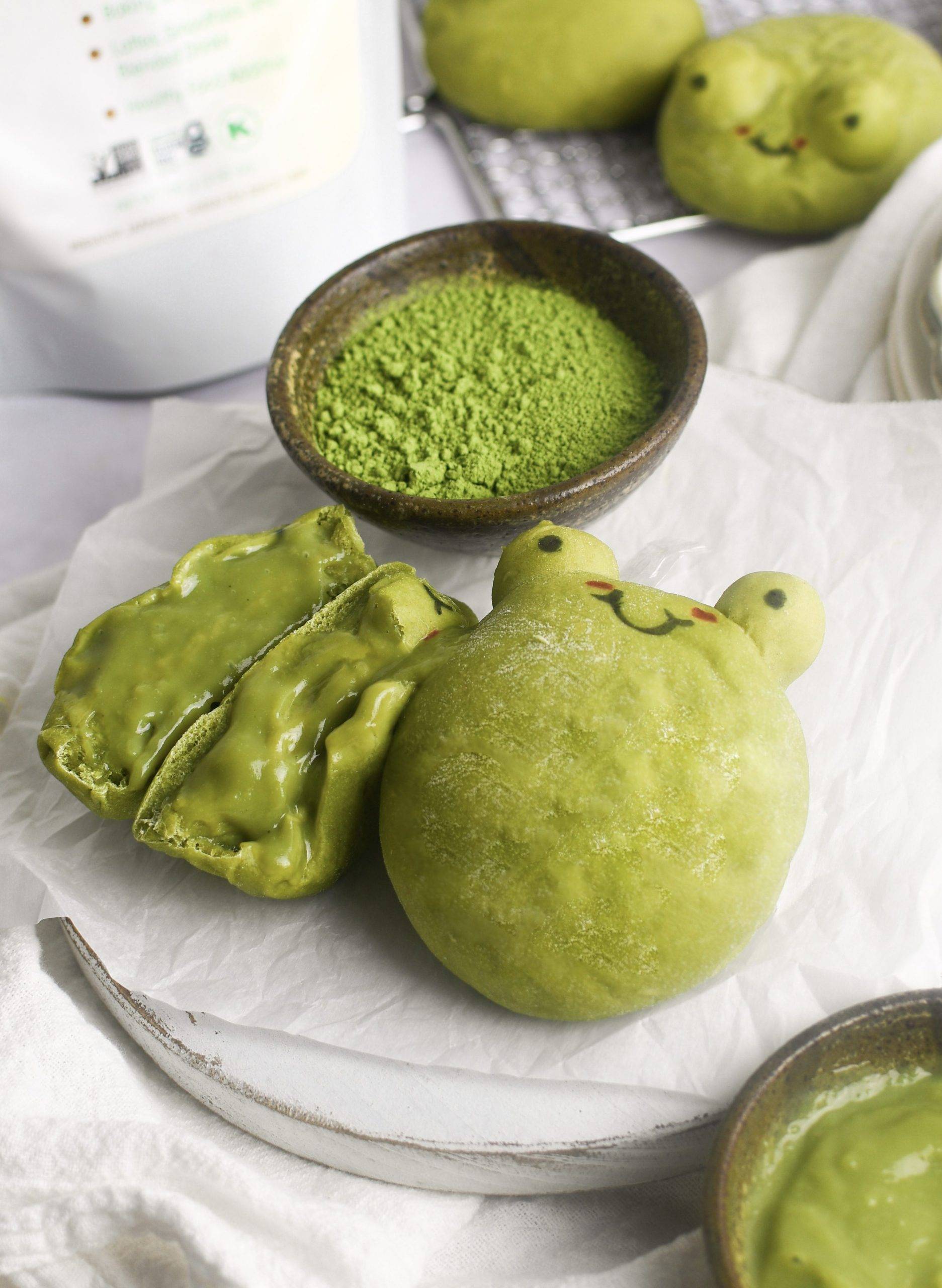 Frog matcha cream buns, one is split open to show the filling