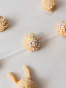 Sugar cookie dough topped with pastel sprinkles.