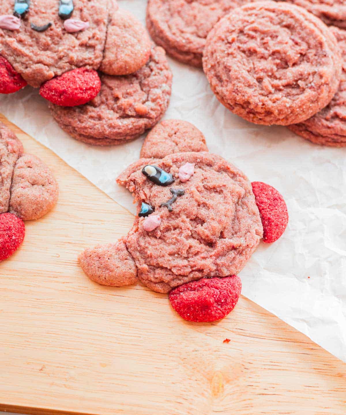 Cute strawberry kirby cookie with a bite taken out of it.