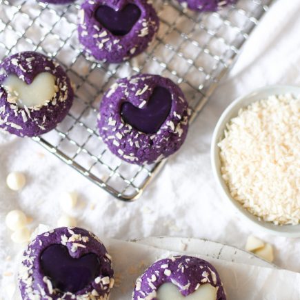 Heart ube thumbprint cookies on a wire rack