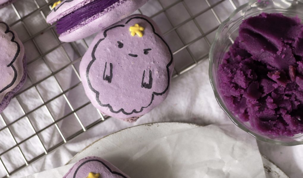 ube cheesecake lumpy space princess macarons on a wire rack w