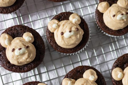 Chocolate peanut butter bear cupcakes on wire rack