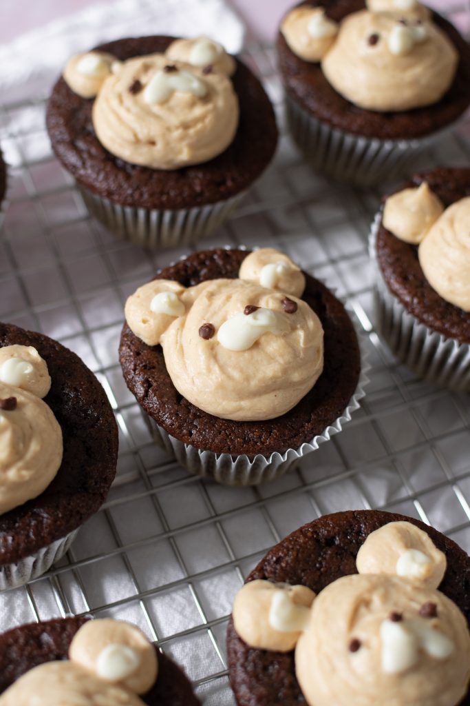 almond flour Chocolate bear cupcakes with peanut butter whipped cream frosting on wire rack