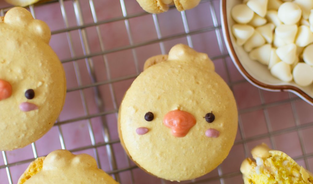 Chick macarons with lemon white chocolate ganache on wire rack