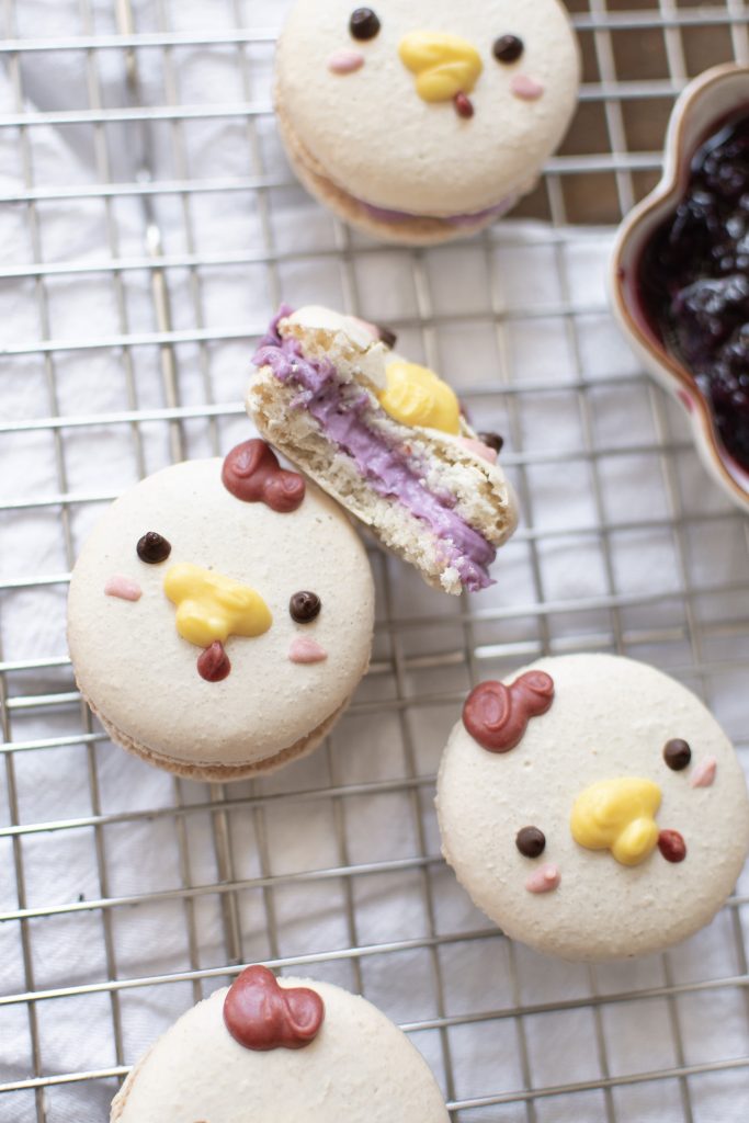 Cute macarons filled with blueberry cheesecake center