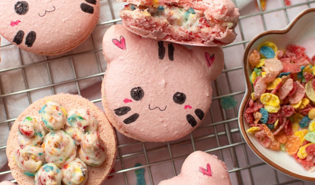 Fruity pebbles cat macarons on a wire rack