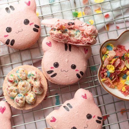 Fruity pebbles cat macarons on a wire rack