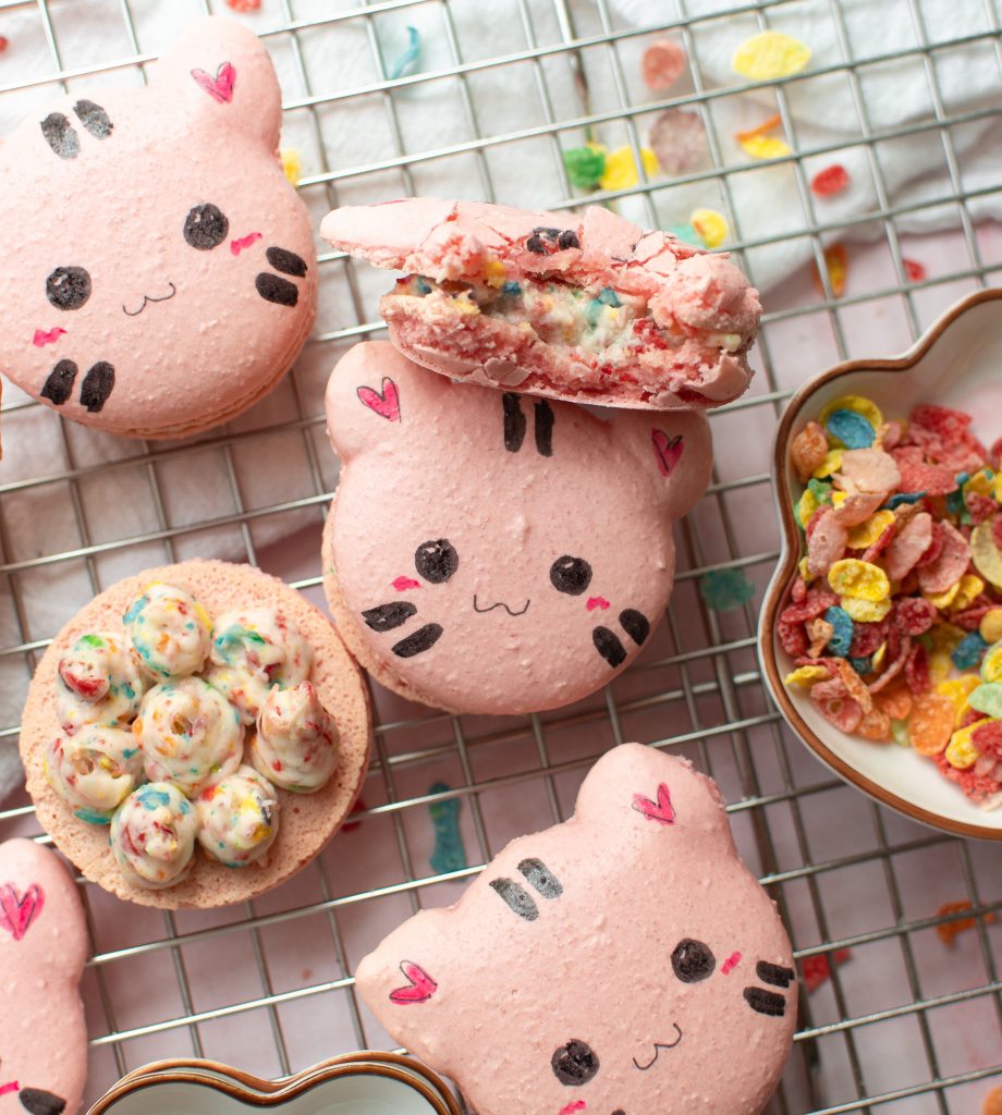 Fruity pebbles cat macarons on a wire rack