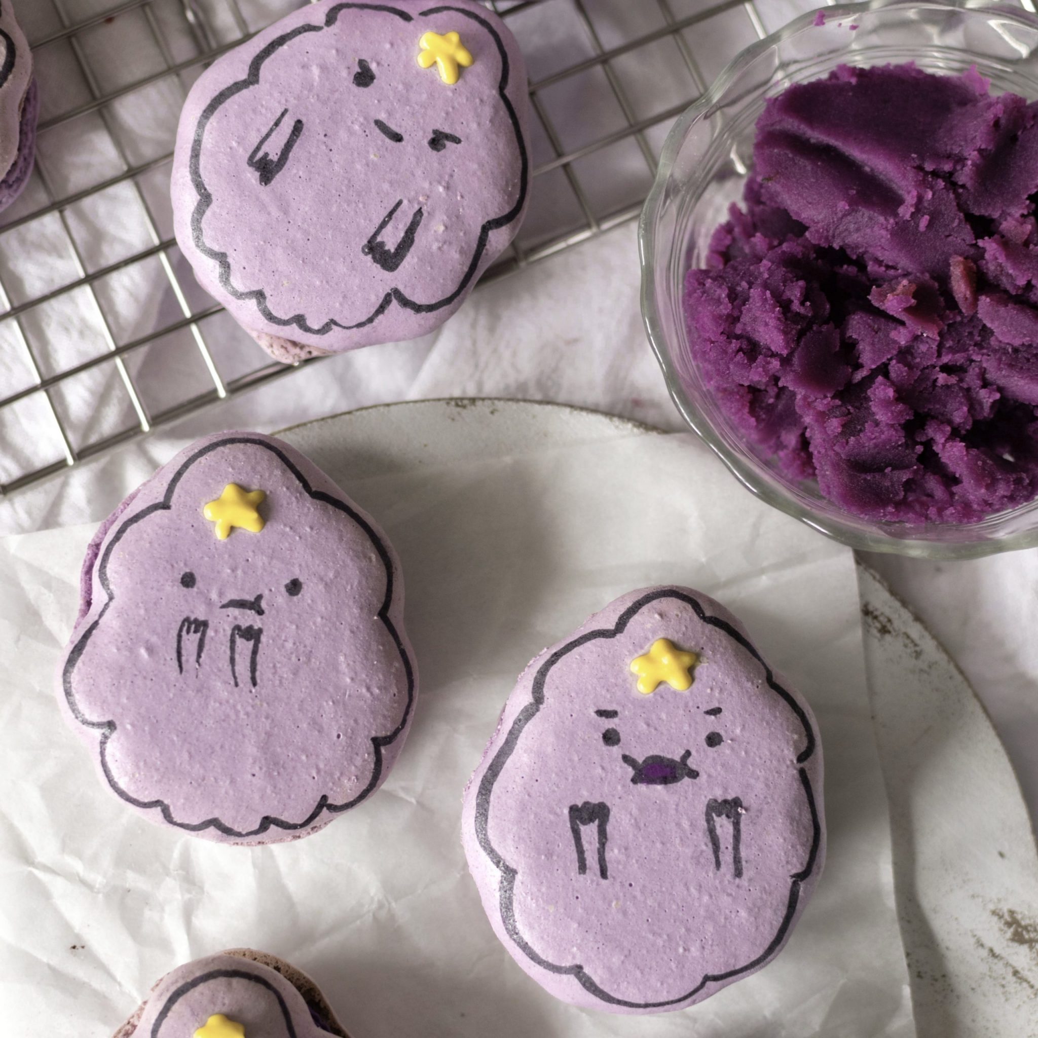 ube cheesecake lumpy space princess macarons on a wire rack w