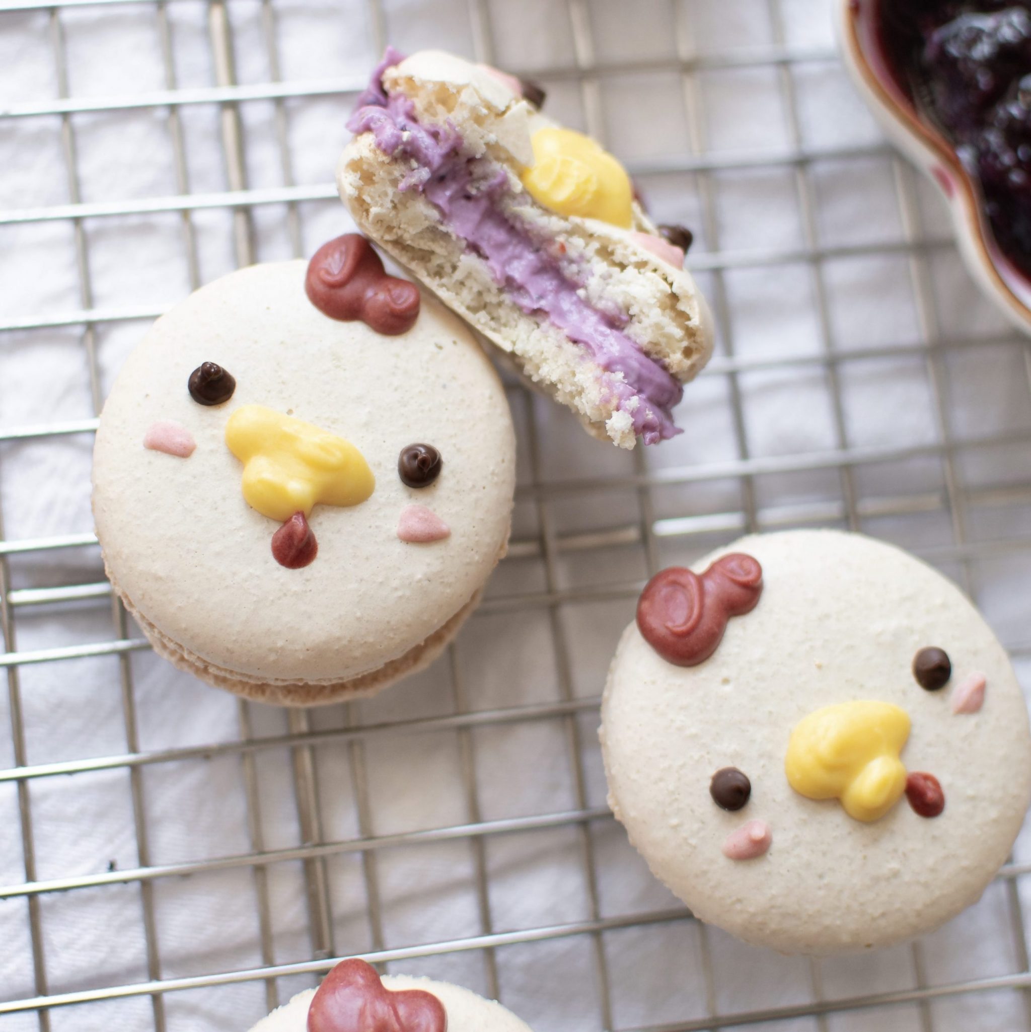 Cute chicken macarons filled with blueberry cheesecake center