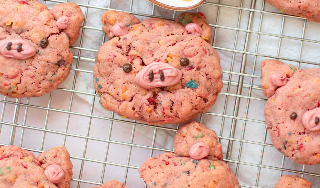Fruity pebbles pig cookies on a wire rack