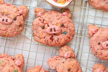 Fruity pebbles pig cookies on a wire rack