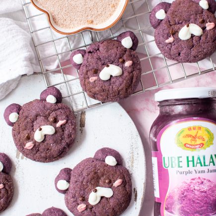 Ube cookies on a wire rack and wooden centerpiece