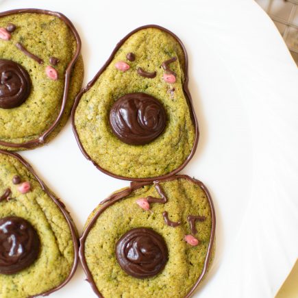 Cute avocado cookies on a white plate