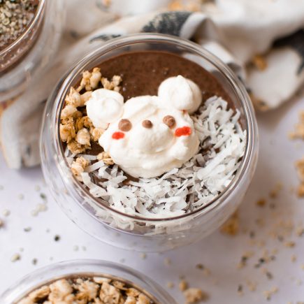 Bear chocolate chia pudding in a glass cup with a white backdrop
