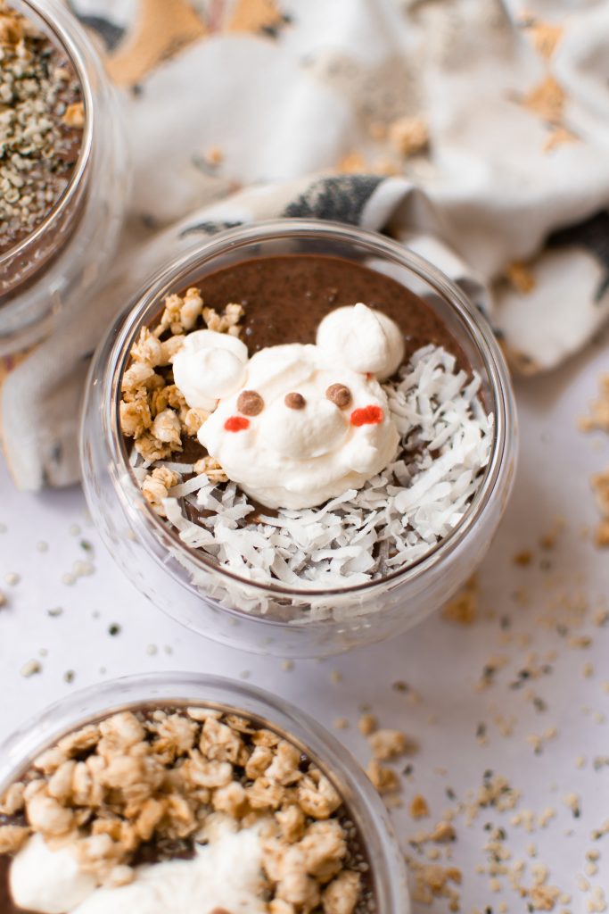 Bear chocolate chia pudding in a glass cup with a white backdrop