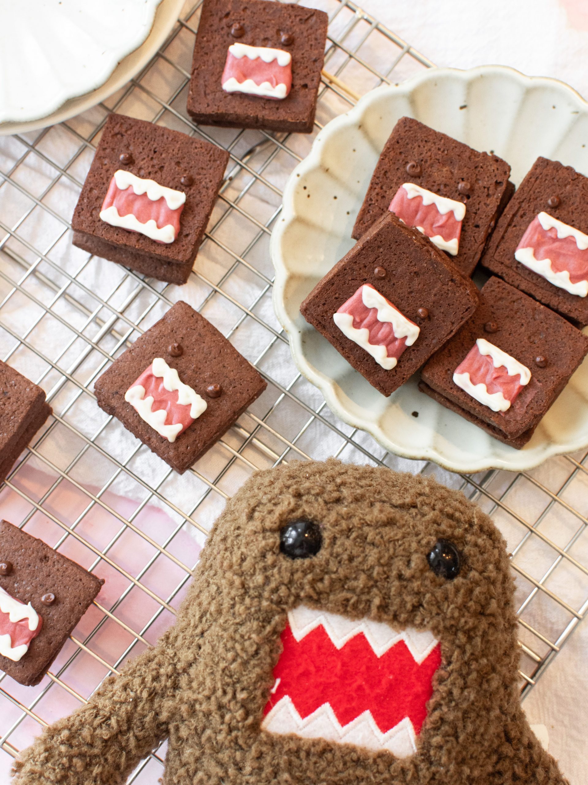 domo cookies on a wire rack with domo plushie
