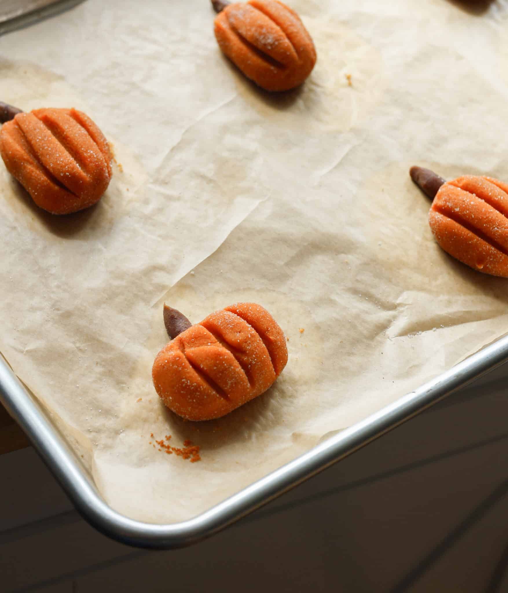 Pumpkin snickerdoodles on tray ready to be baked.