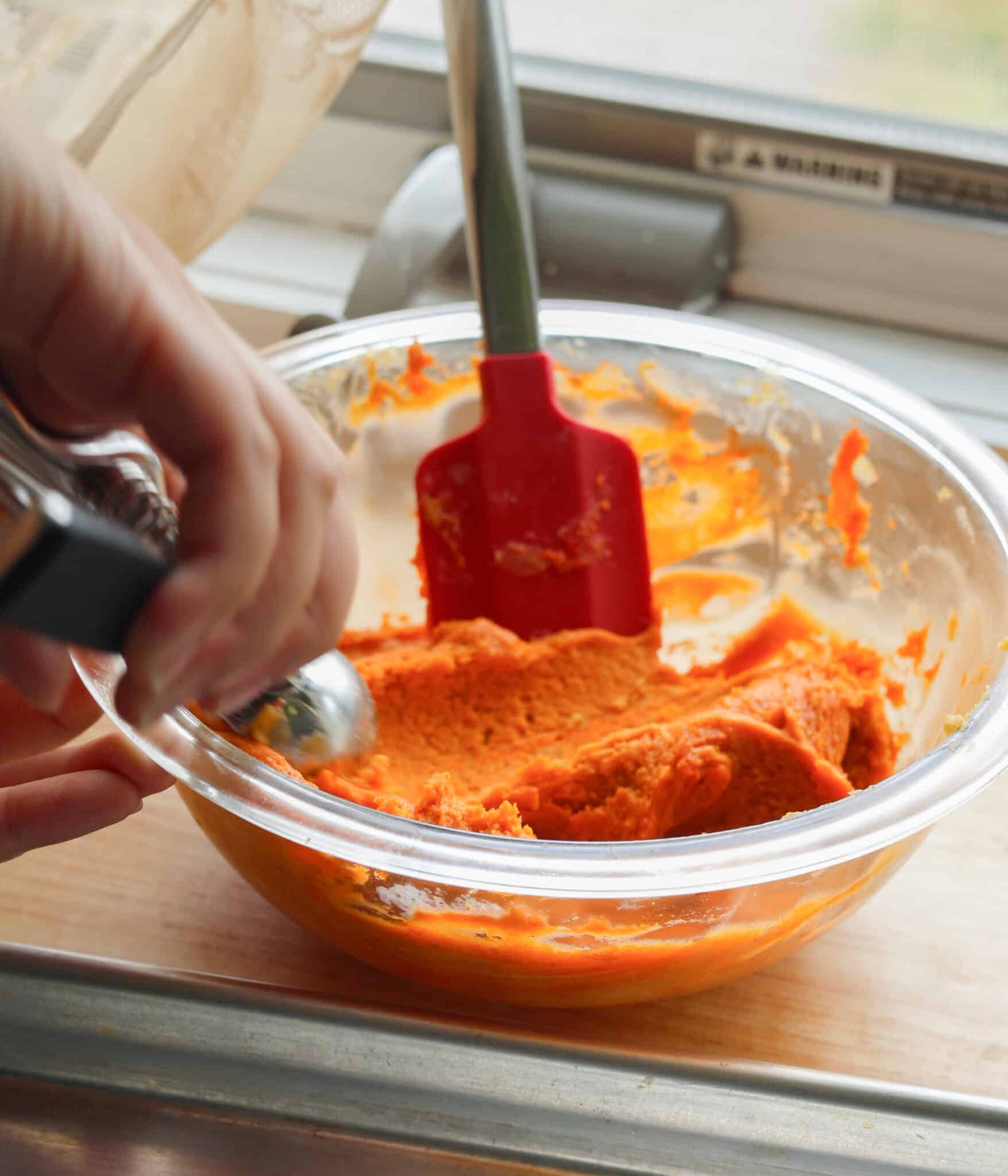 Pumpkin snickerdoodle dough in a glass bowl.