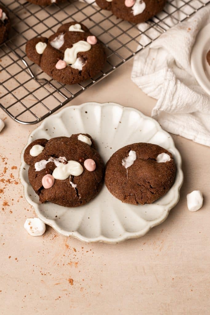 Hot chocolate cookies on a scalloped plate.