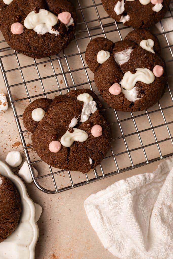 Bear shaped chocolate marshmallow cookies on a wire rack.