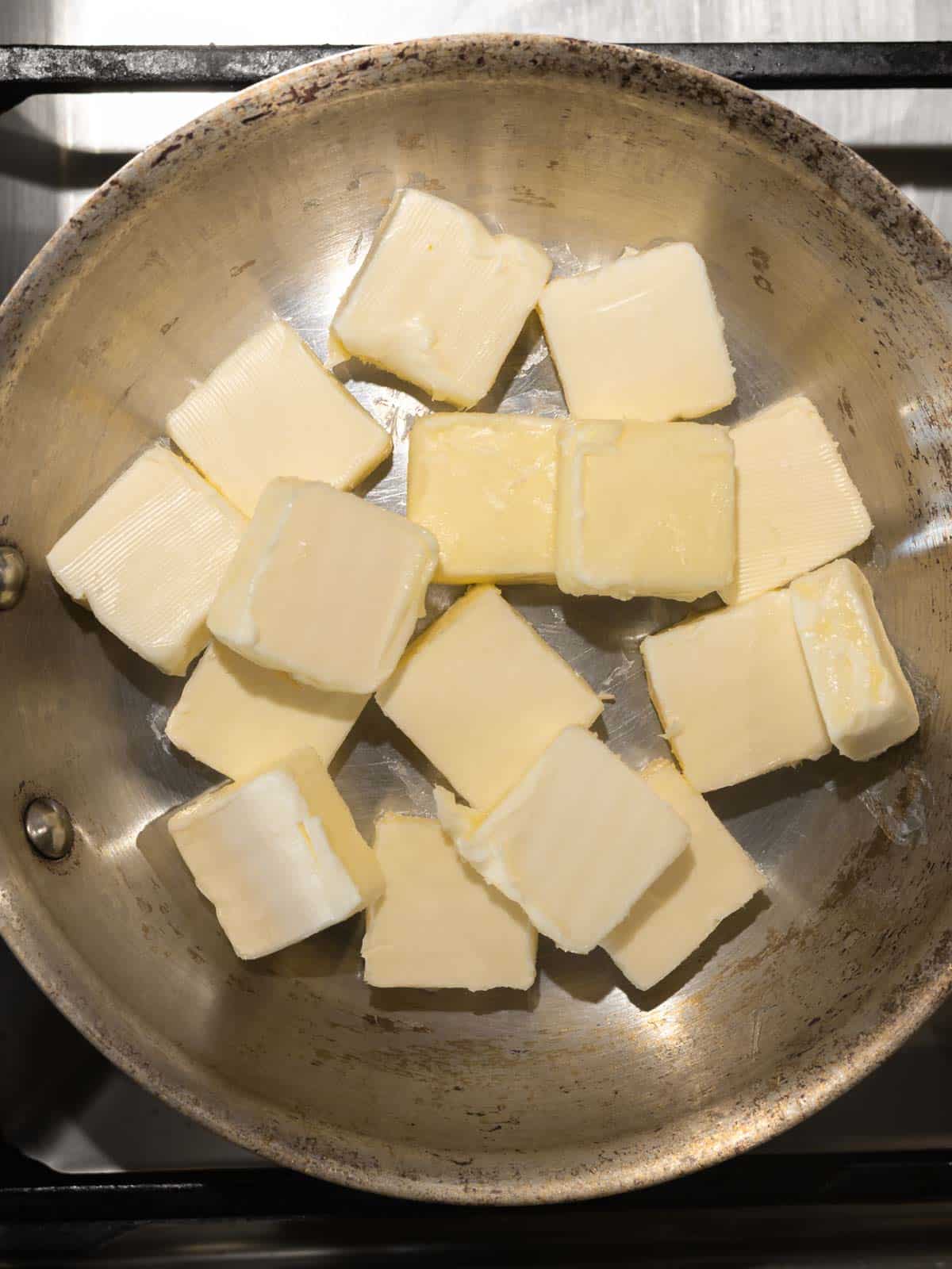 Butter cut into tablespoons in a light colored pan.