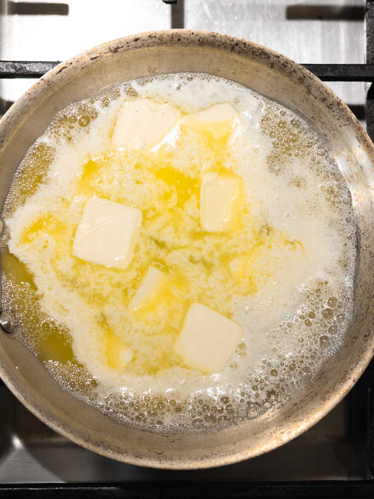 Butter melting in light colored pan.