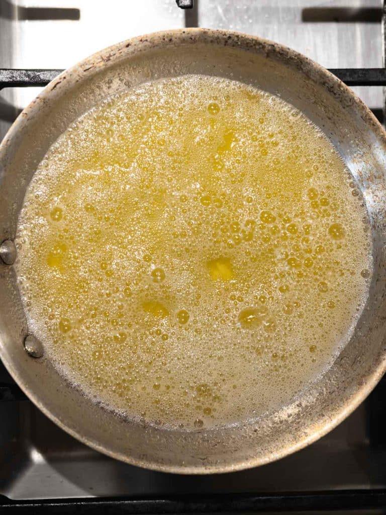 Melted butter in stainless steel pan.