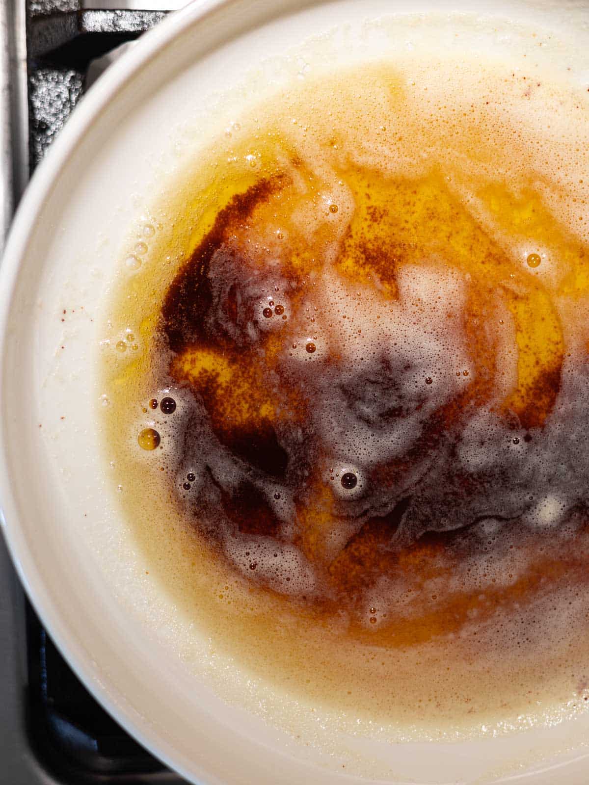 Melted brown butter in a white bowl. 