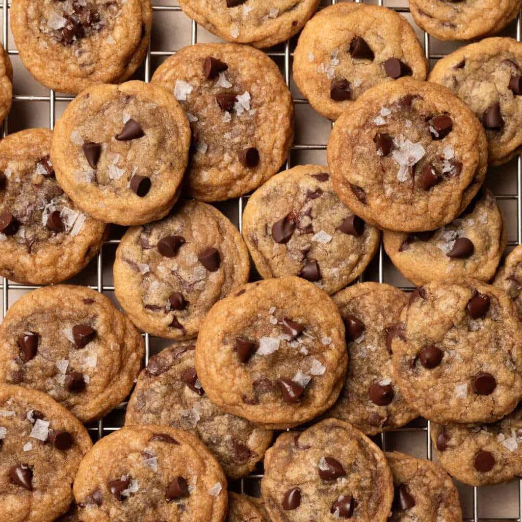 mini chocolate chip cookie bites layered on a wire rack