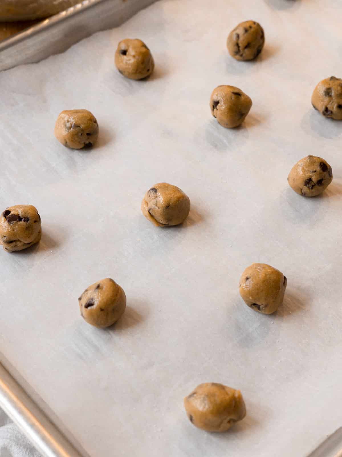 Mini cookies on lined baking tray ready to be baked. 