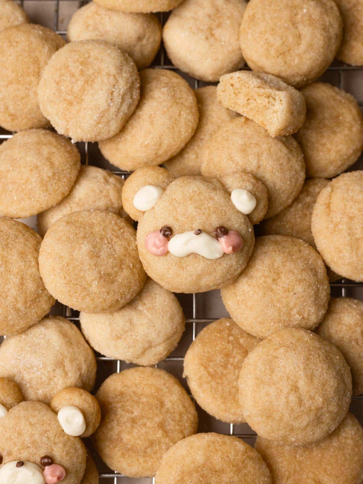 Mini sugar cookies layered on top of each other on a wire rack.