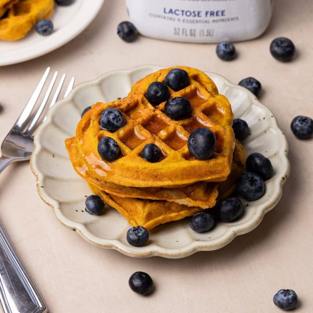 pumpkin waffles topped with maple syrup and blueberries. shot using my new food photography gear, Canon EOS R6 MII and 50 mm f/1.8 lens.