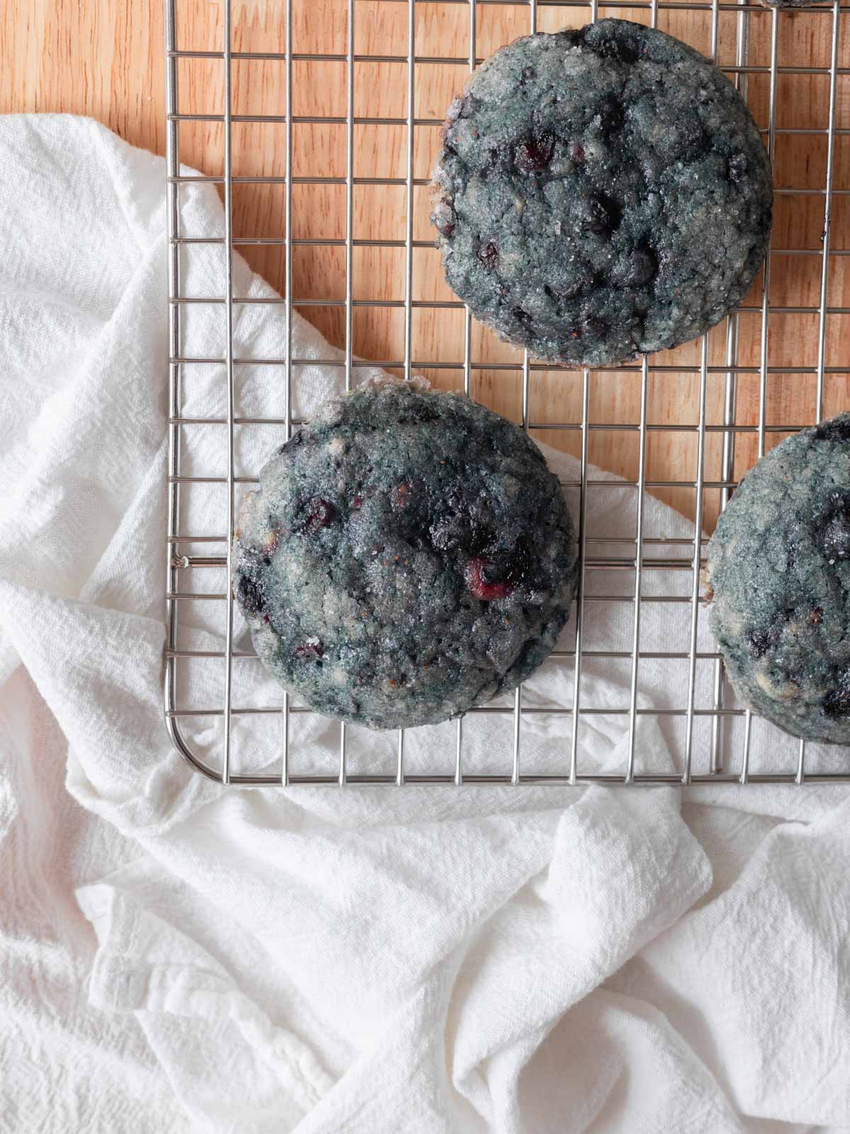 Baked blueberry sugar cookies on wire rack.