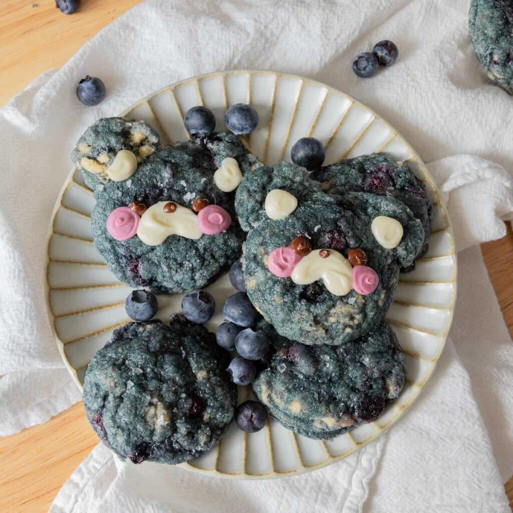 Cute blueberry cookies on a white plate.