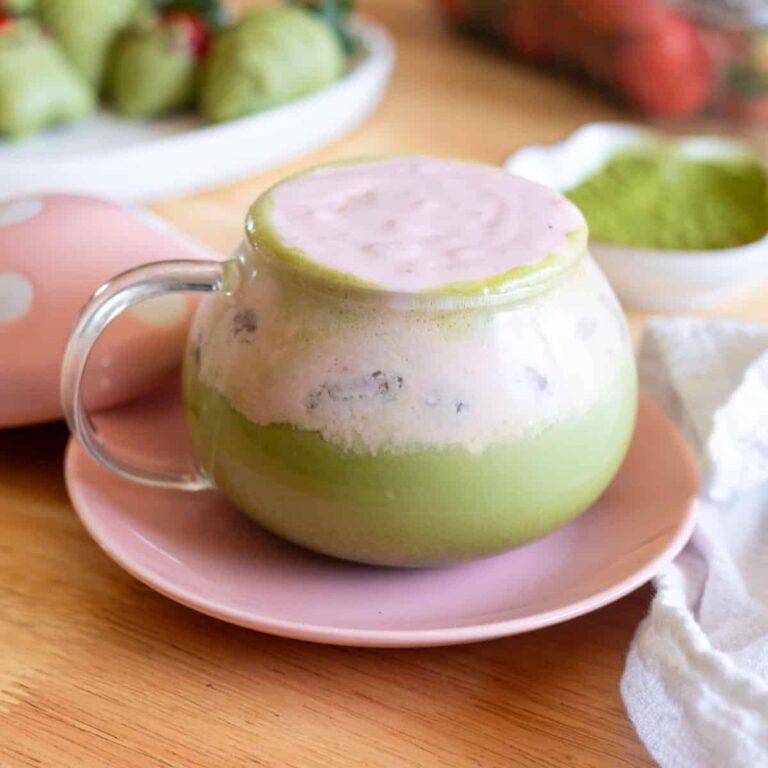 Matcha latte with strawberry cold foam in a glass mug