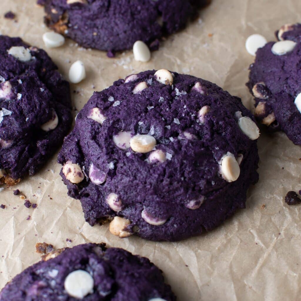 Chunky ube cookies with white chocolate and shredded coconut.